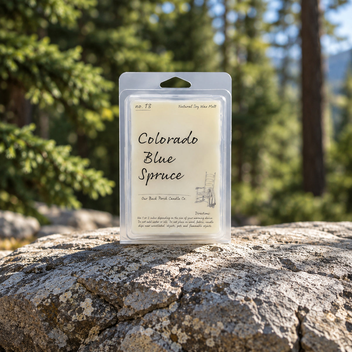 Colorado Blue Spruce soy wax melt by Back Porch Candle Co. in a forest and mountain setting.