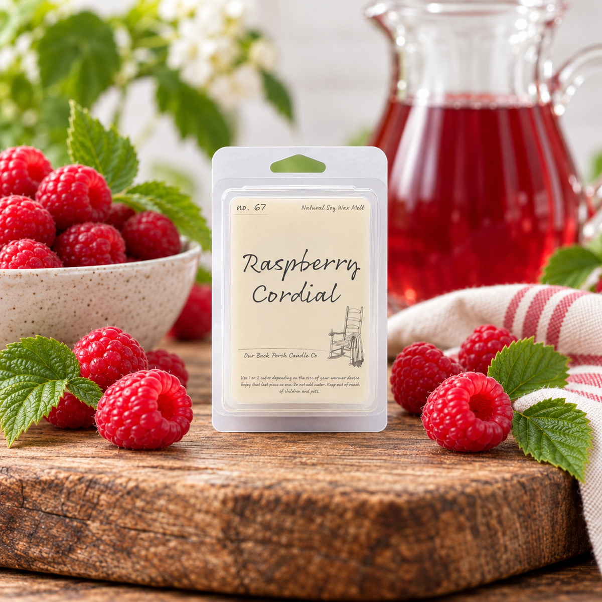 Back Porch Candle Co Raspberry Cordial 6 oz soy wax melt styled with raspberries and raspberry cordial in a warm rustic setting.