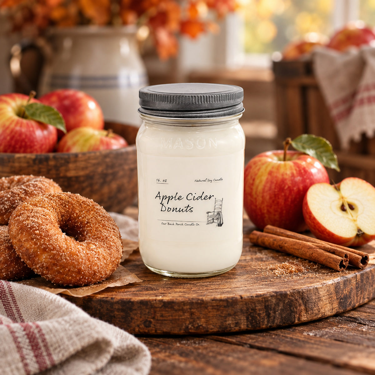Apple Cider Donuts 16 oz soy candle by Back Porch Candle Co. with apples, cider donuts, and cinnamon in a warm farmhouse setting.