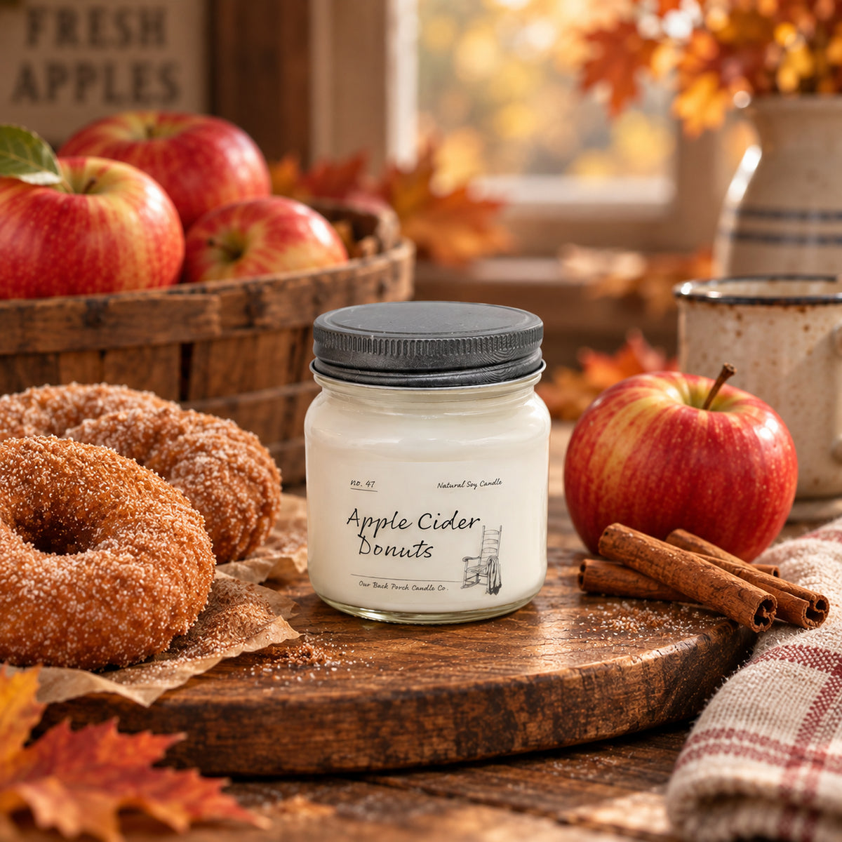 Apple Cider Donuts 8 oz soy candle by Back Porch Candle Co. with apples, cider donuts, and cinnamon in a warm farmhouse setting.