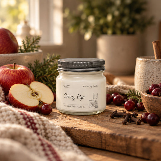 Cozy Up 8 oz soy candle by Back Porch Candle Co. in a warm setting with apples, berries, cinnamon, clove and evergreen.