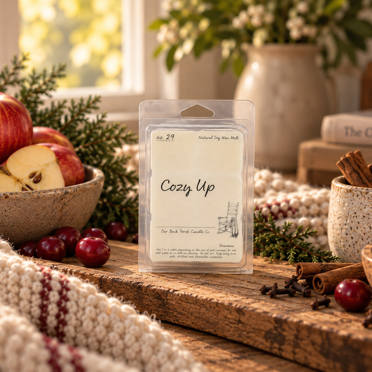 Cozy Up soy wax melt by Back Porch Candle Co. styled with apples, berries, cinnamon, cloves and cypress greenery.