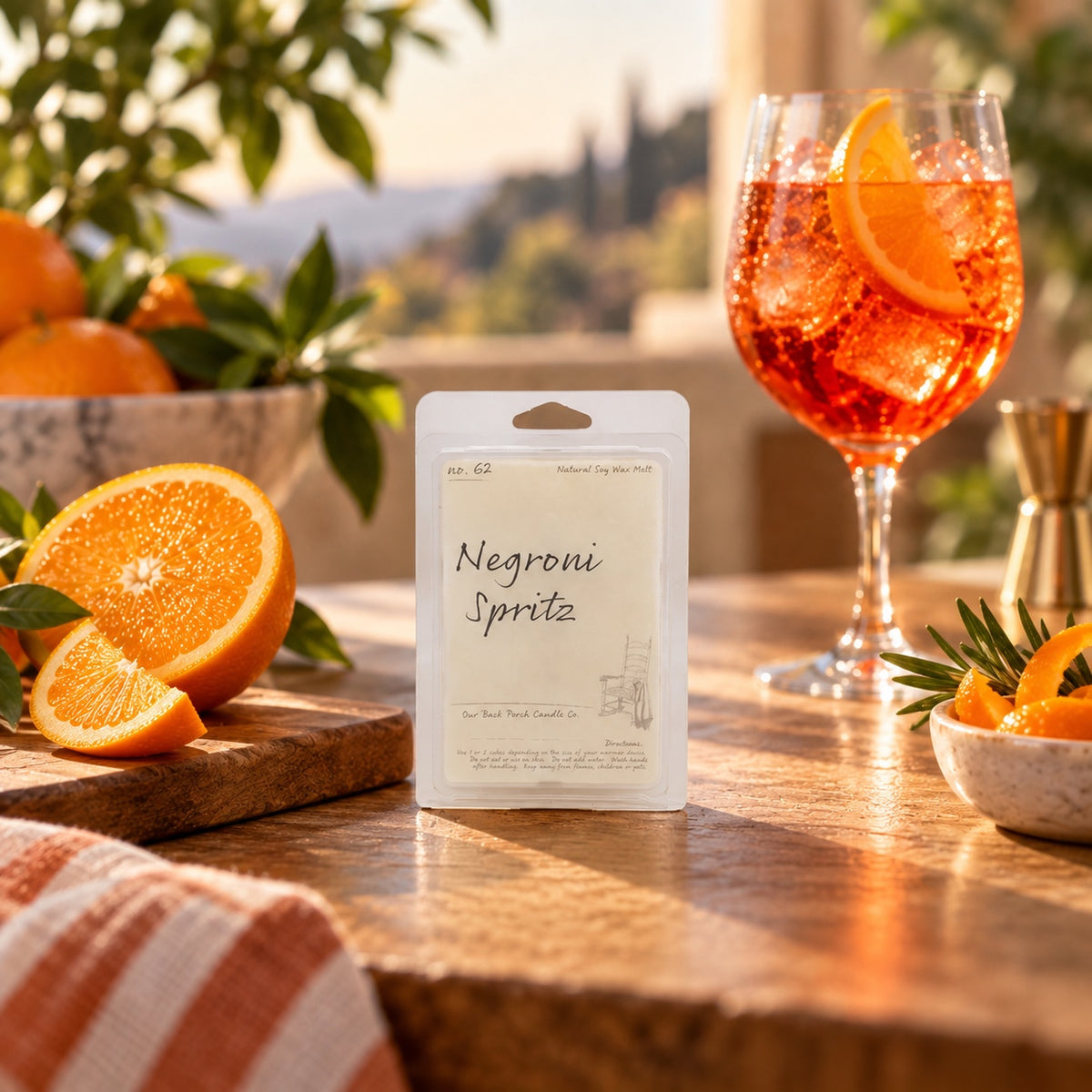 Negroni Spritz soy wax melt by Back Porch Candle Co. styled with orange peel and a sparkling aperitivo-inspired scene.