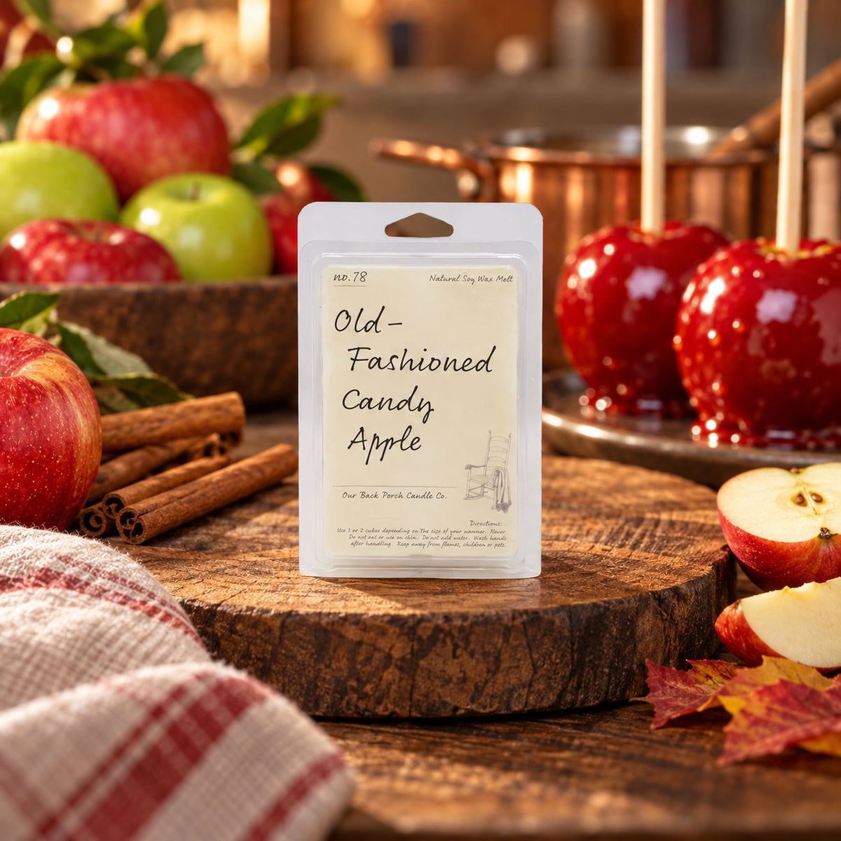 Old-Fashioned Candy Apple soy wax melt by Back Porch Candle Co. styled with apples, cinnamon, and warm autumn kitchen details.
