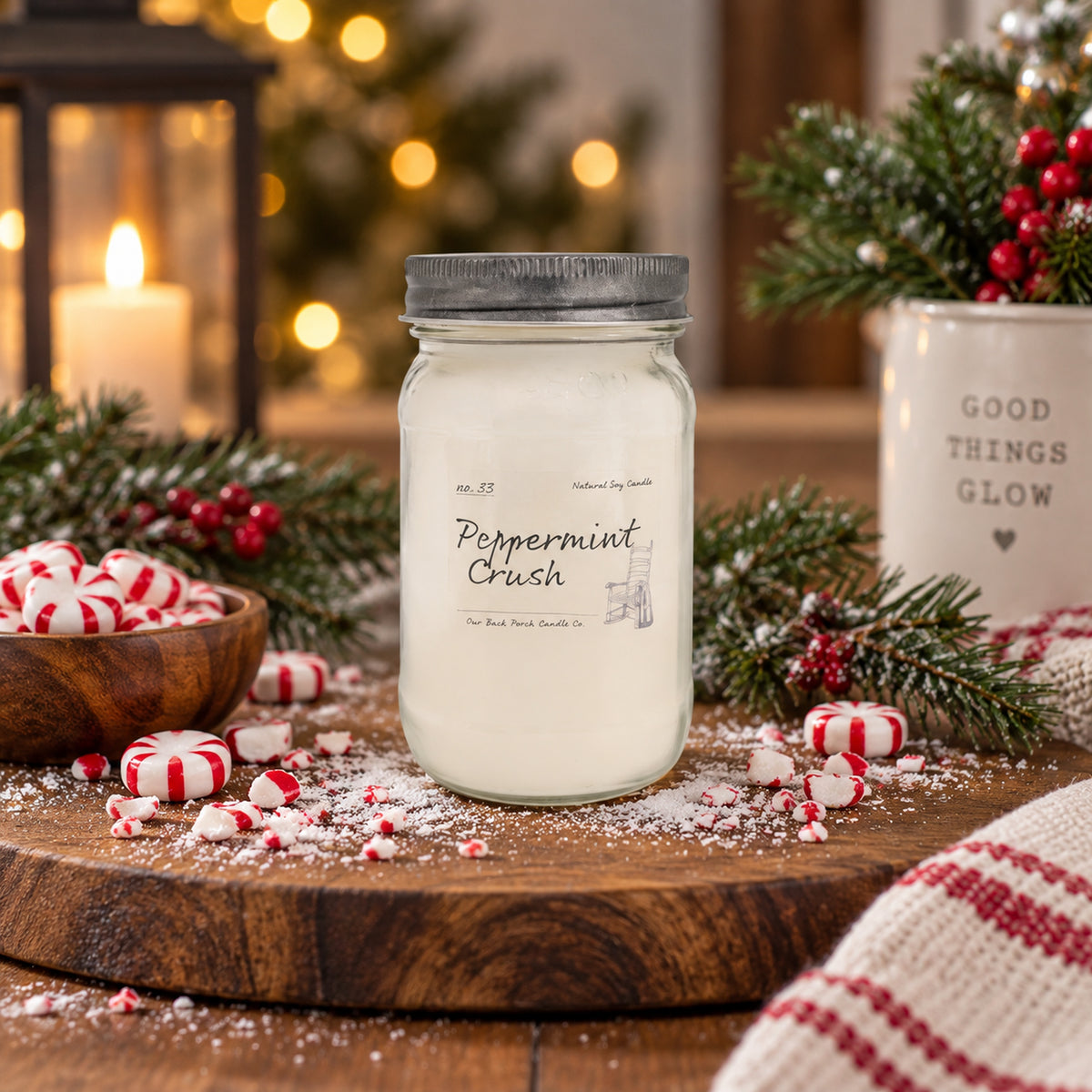 Peppermint Crush 16 oz soy candle by Back Porch Candle Co. styled with fresh mint, cool peppermint, sweet vanilla, evergreen, and warm holiday light.