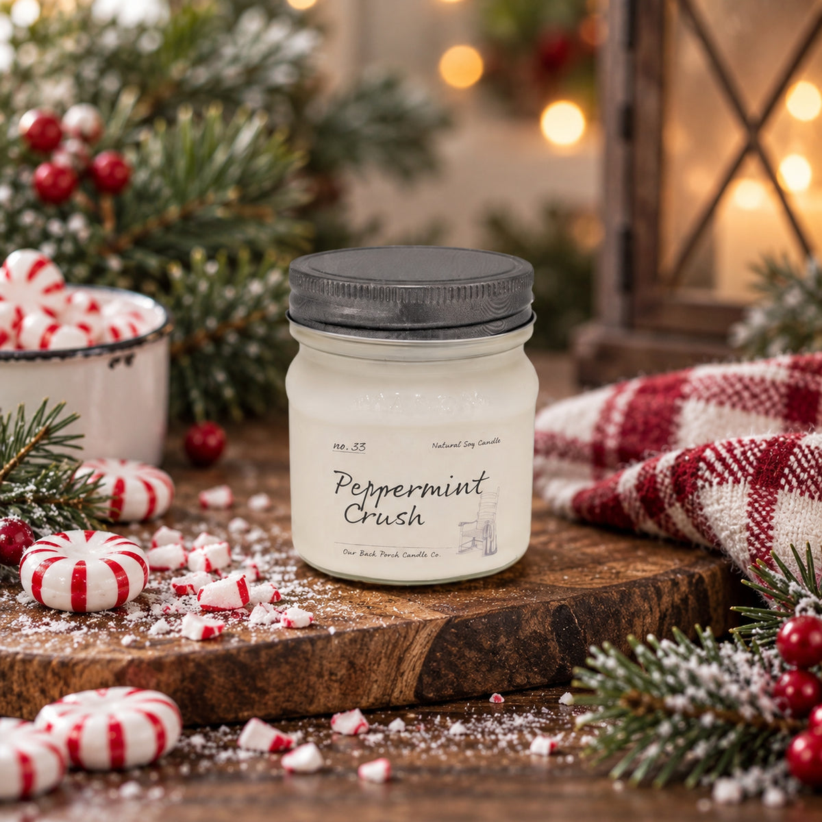 Peppermint Crush 8 oz soy candle by Back Porch Candle Co. styled with peppermint candy, evergreen, and cozy winter details.