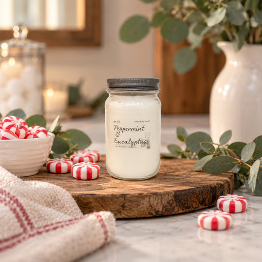 Peppermint & Eucalyptus 16 oz soy candle by Back Porch Candle Co. styled in a fresh spa-inspired setting with eucalyptus and peppermint.